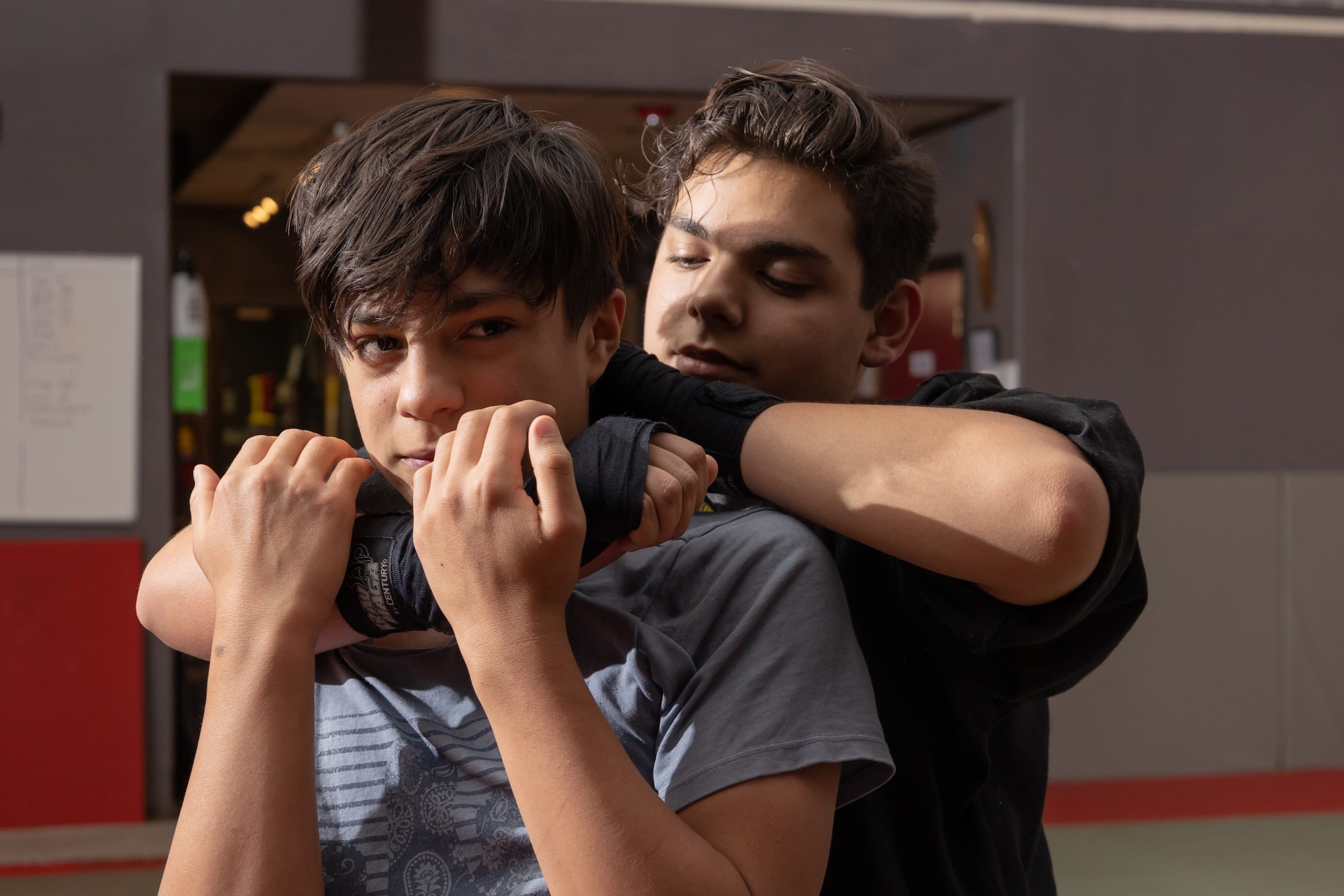 two students at homeland heroes sparring in jujutsu class practicing proper holds