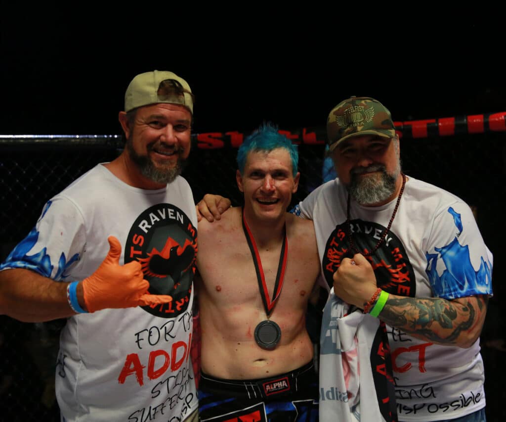 Homeland Heroes posing with the mma match winner