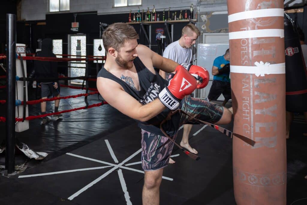 homeland heroes students kicking punching bags for boxing and mma class