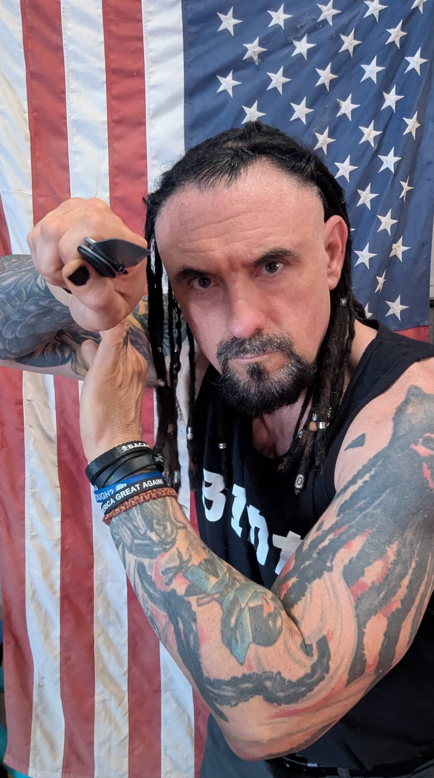 Homeland Heroes Owner Raven Cain holding a knife to demonstrate his defender program